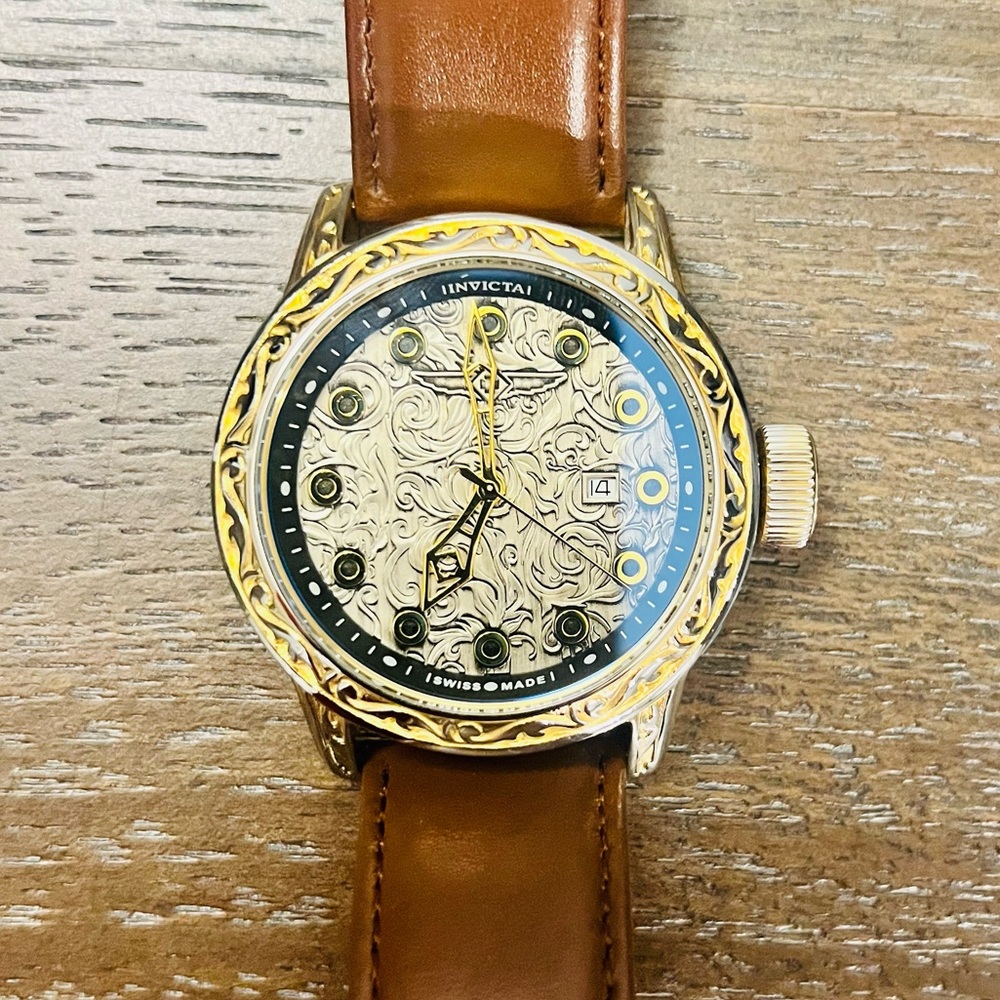 Invicta Vintage, Gold and engraved case with brown strap. Model # 20547. 52mm